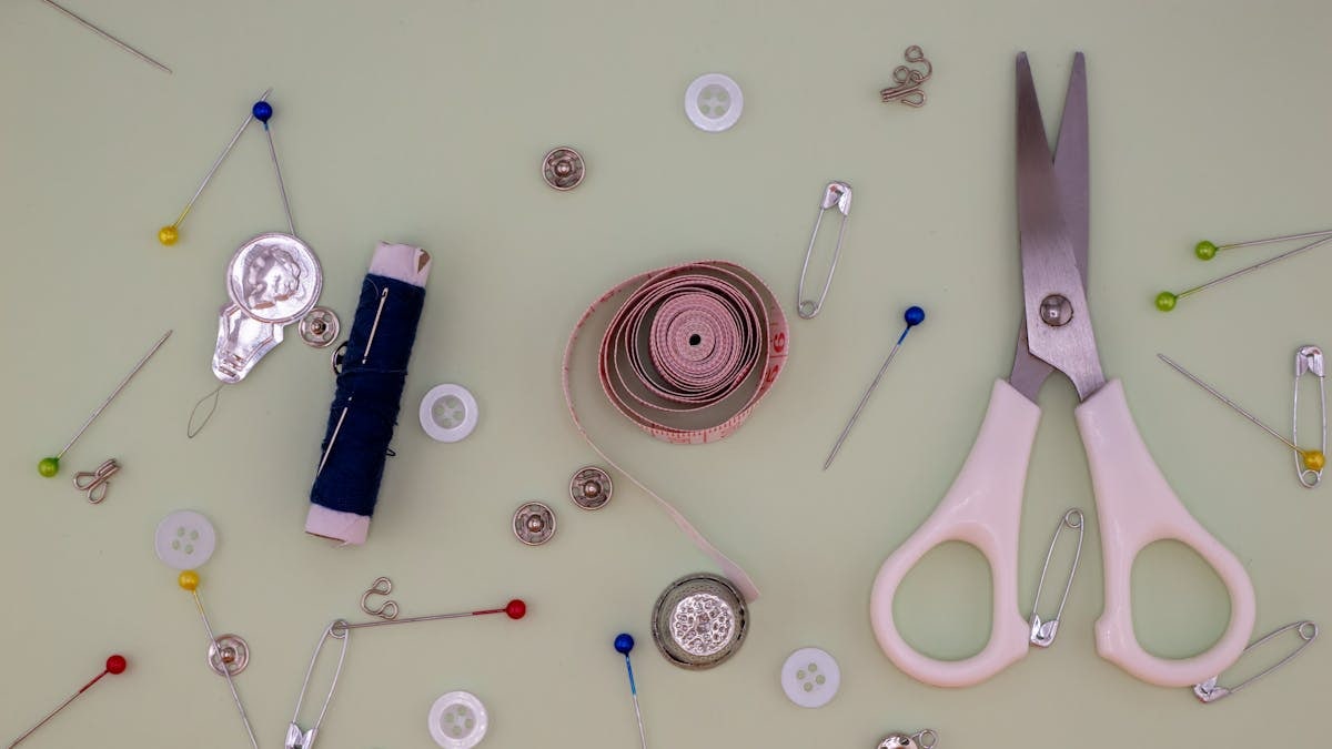 Sewing essentials including scissors, tape measure, and thread displayed neatly on a table.